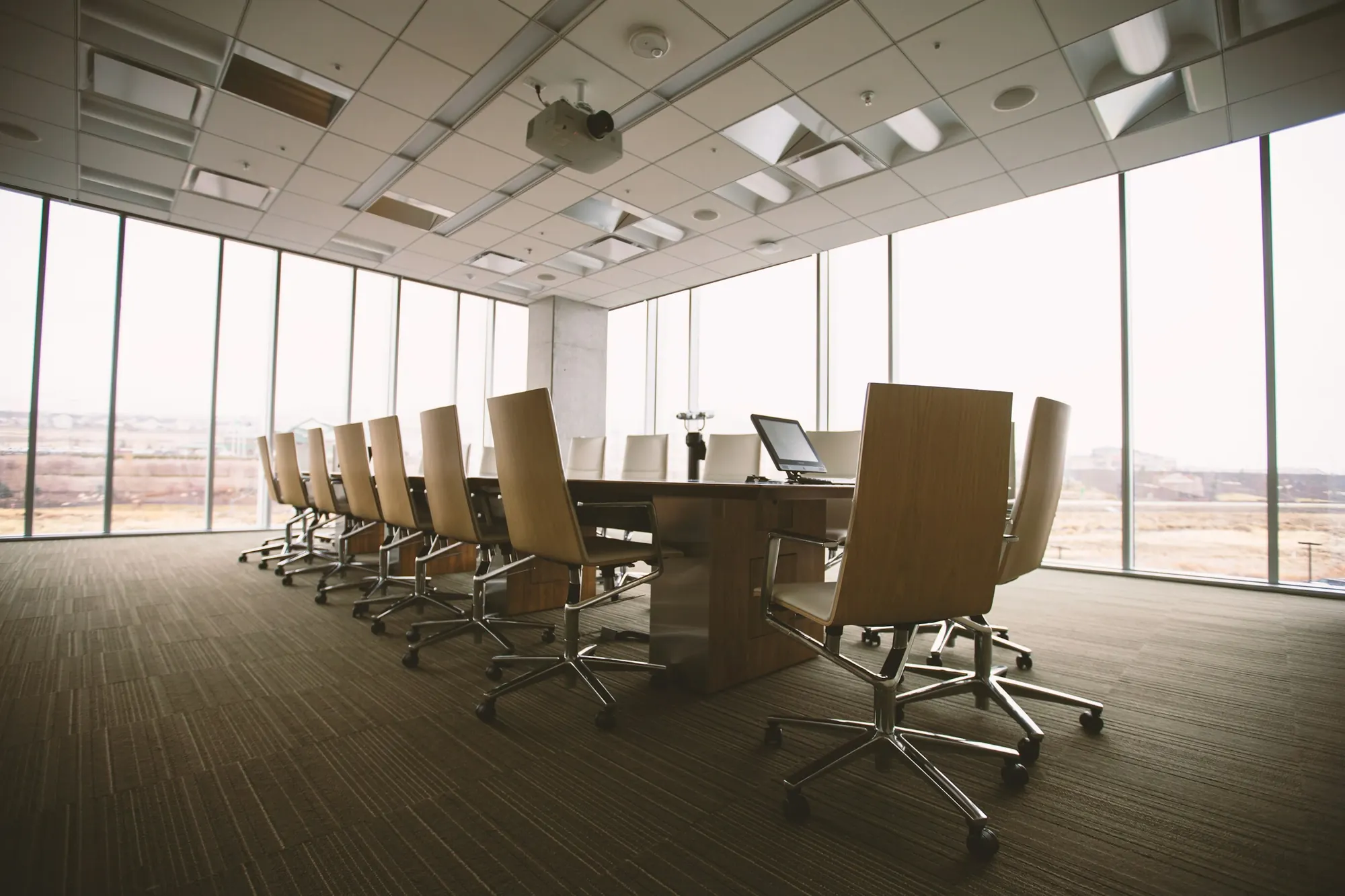 Boardroom with a long table and floor-to-ceiling windows